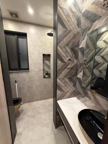 a bathroom with a shower and a sink and a toilet at Prestige Home in Lahore