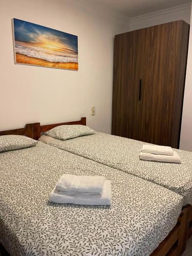 a bedroom with two beds with white towels on them at Simat Malina 2 in Simat de Valldigna