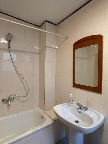 a bathroom with a sink and a tub and a mirror at Simat Malina 2 in Simat de Valldigna