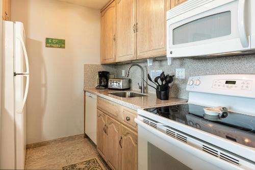 a small kitchen with a sink and a microwave at SUGAR BEACH RESORT, #319 in Kihei
