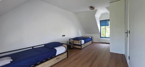 a bedroom with two beds and a window at Ker Giz 14 in Arzon