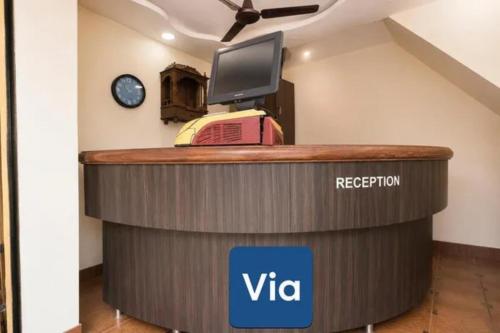 a visa reception desk with a television on top at Via Sagar Darshan in Panaji