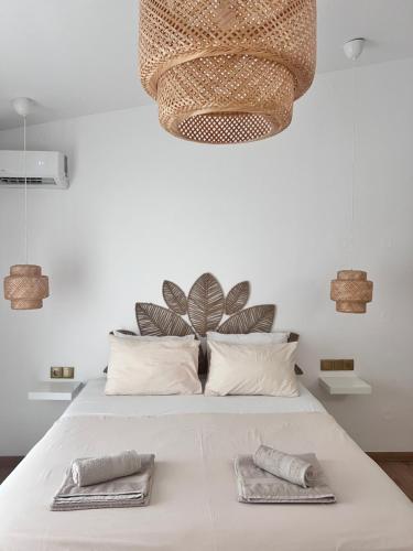 a bedroom with a bed with two towels on it at Ραστώνη in Tolo