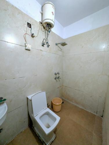 a bathroom with a toilet and a sink at Classic Hotel in Pānīpat