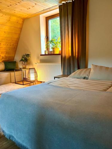a bedroom with a large bed and a window at Green-in in Jaklovce