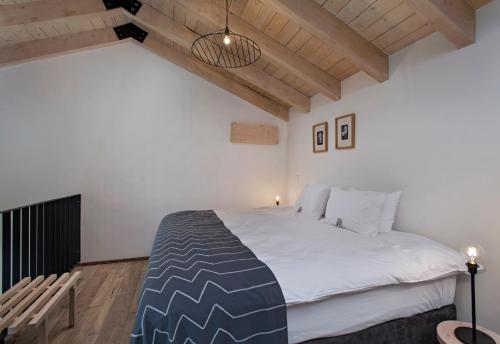 Un dormitorio con una cama grande en una habitación con techos de madera. en Good Hotel Antigua en Antigua Guatemala