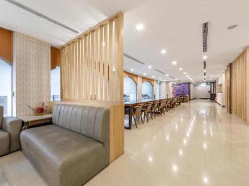 a long hallway with chairs and tables in a building at Doitsu Hotel in Taipei