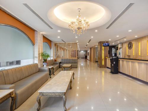 a lobby with couches and a chandelier at Doitsu Hotel in Taipei