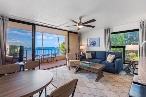 a living room with a blue couch and a table at SUGAR BEACH RESORT, #235 in Kihei
