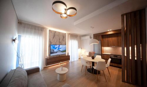 a living room with a couch and a table with chairs at Arcadian Design Loft in Tripoli