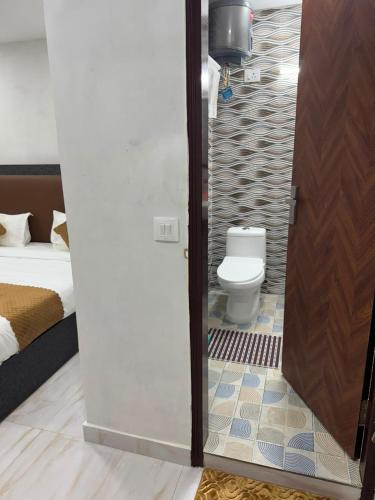 a bathroom with a toilet in a room at Hotel Vasundhara Villa - Greater Kailash in New Delhi