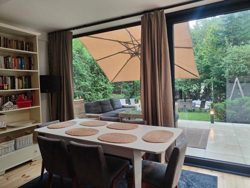 a living room with a table and a large window at Kamińsko 544 in Kamińsko