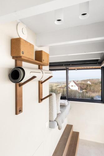 a view from the living room of a house with a large window at Duinhotel Tien Torens in Zoutelande