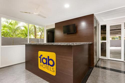 a hotel lobby with a mobo hotel sign on a counter at FabHotel Excella Vizag in Visakhapatnam