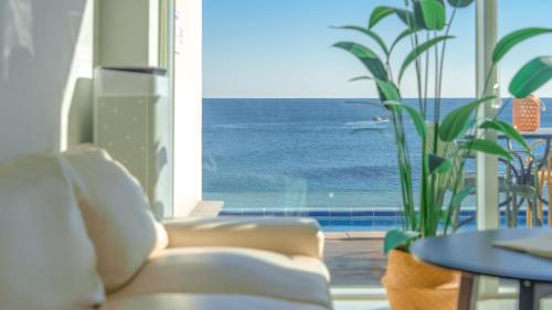 a living room with a couch and a view of the ocean at Yeongdeok The Best Pool Villa in Yŏngdŏk