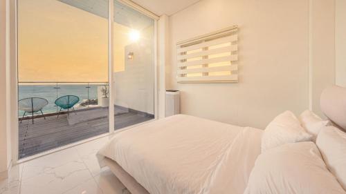 a bedroom with a bed and a view of the ocean at Yeongdeok The Best Pool Villa in Yŏngdŏk