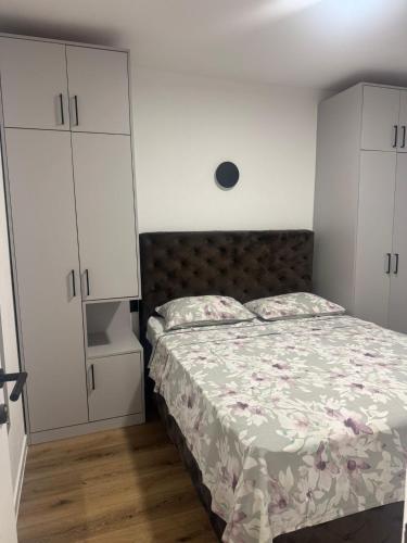 a bedroom with a bed and white cabinets at House 100m from the beach with free parking in Baška Voda
