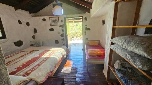 a room with two bunk beds and a hallway at Finca Cueva del Viento in Icod de los Vinos