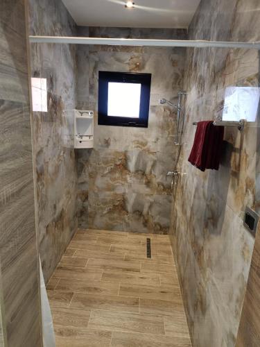 a bathroom with a shower with a window at Villa jenni in Temlale