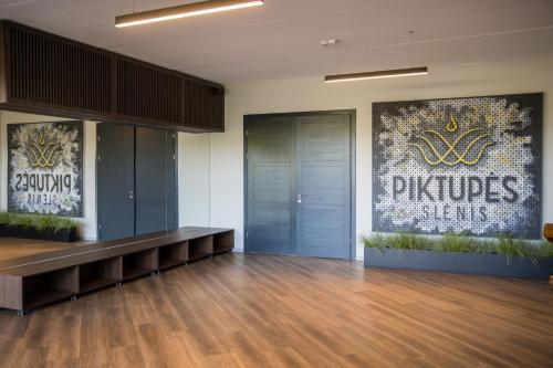 a room with a dance floor with two elevators and a wall at Piktupės slėnis in Piktupėnai