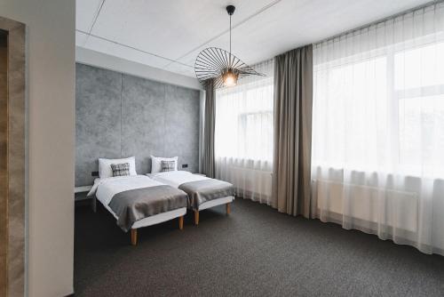 a bedroom with a bed and a large window at Piktupės slėnis in Piktupėnai