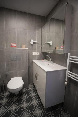 ein Badezimmer mit weißer Toilette und Waschbecken in der Unterkunft DORA BEYTEPE HoTEL in Çayyolu