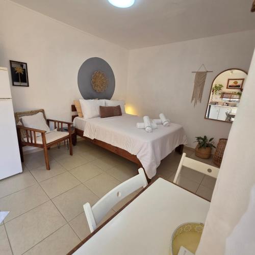 a bedroom with a bed and a chair in it at כרמונ'ס פטיו - Carmona's Patio in Eilat