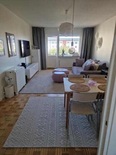 a living room with a couch and a table at Central lägenhet i Visby -4 person inkl parkering in VBY