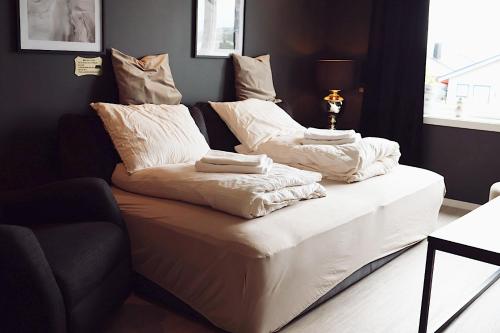 a couch with pillows on it in a living room at Arctic City Suites 1 in Kirkenes