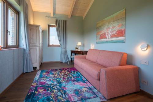 a living room with a couch and a rug at I Quattro Pozzi in La Morra