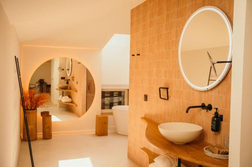 a bathroom with a sink and a mirror at La Venta de Bodegas Ostatu in Samaniego