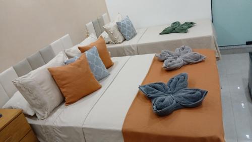 two couches with pillows on top of them at Suítes Rufino in Lençóis