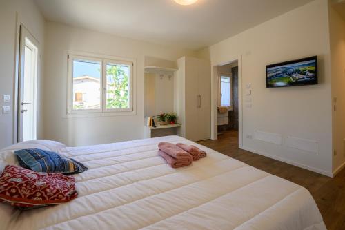 a bedroom with a large white bed with pillows on it at Residence Da Marco in Pieve di Soligo