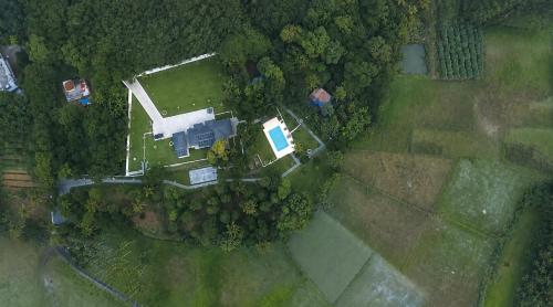 an overhead view of a yard with a house and trees at Le Jardin - Luxury Private Pool Villa near Kochi, Kerala in Cochin