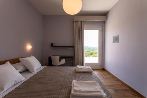a bedroom with a large bed with a window at Agriturismo Fontanavecchia in Torrecuso
