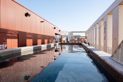 a pool of water between two buildings at JOST Hôtel Bordeaux Centre Gare Saint Jean in Bordeaux