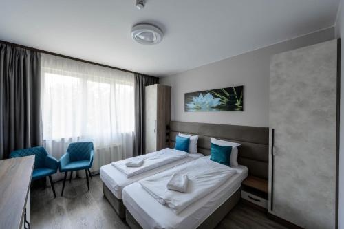 a hotel room with a bed and a table and chairs at Vital Hotel in Sofia
