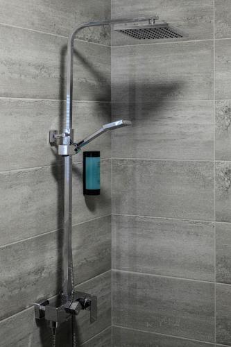 a shower with a shower head in a bathroom at Vital Hotel in Sofia