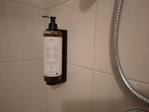 a soap dispenser on the wall of a shower at B&B Campisi Anna in Altamura