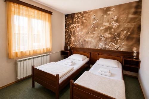 a room with two beds and a window at Picikato Rooms in Krapina