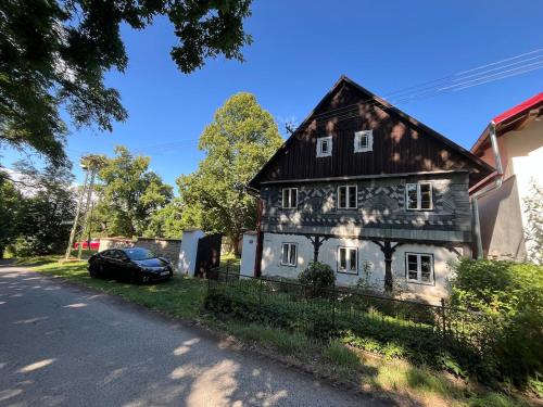 a black and white house on the side of a street at Chalupa Hubina in Snědovice