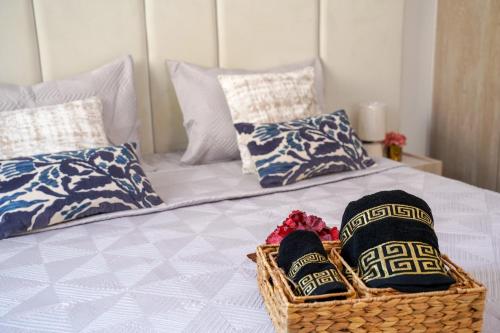 a bed with two baskets and two pillows on it at Modern Hammamet Stay Pool & Beach in Hammamet Sud