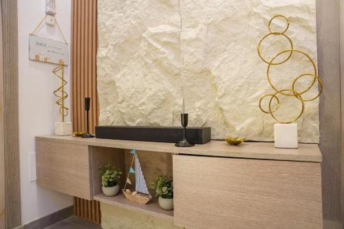a wooden cabinet with plants on top of it at Modern Hammamet Stay Pool & Beach in Hammamet Sud