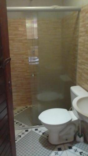 a bathroom with a shower and a toilet and a sink at Hostel Kay Pacha e Camping in Maceió