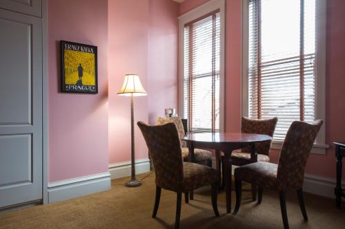 a dining room with a table and chairs and a lamp at Montvale Hotel in Spokane