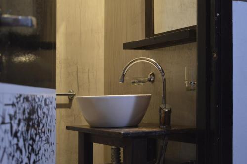 a white bowl sink on a counter in a bathroom at Hotel Vial Center in Mar del Plata