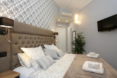 Ліжко або ліжка в номері Capricci Romani