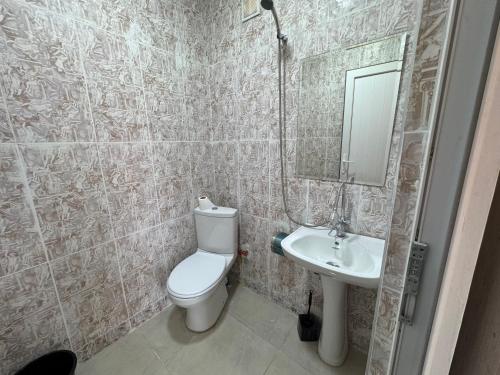a bathroom with a toilet and a sink at Chocolate in Ureki