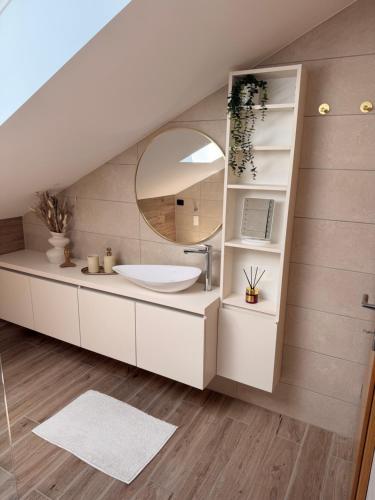 a bathroom with a sink and a mirror at Apartma Julia in Semič