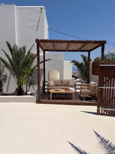 a gazebo with a couch and a table at Breaq Santorini - Margarita Hotel in Firostefani